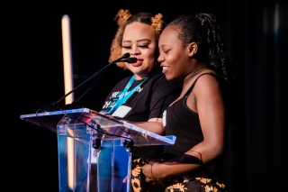 Two people at the podium of a Friends of the Children friendsraiser