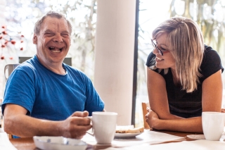 Two people smiling together representing a volunteer match for Guardian Partners