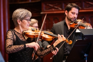Two violinists with the Portland Baroque Orchestra