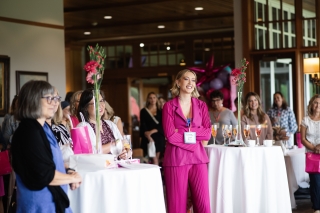 Women standing at high-top tables at a Fighting Pretty event