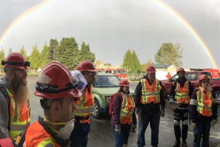 Portland Neighborhood Emergency Team gathering together with a double rainbow in the background