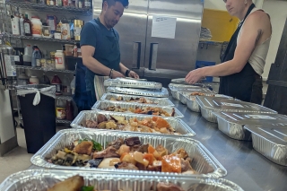 Several turkey and vegetable dinners lined up in a kitchen