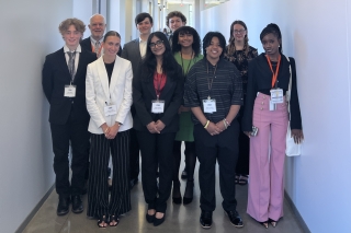 Business students pose with OBA volunteers in the hallway