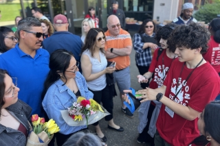 Oregon business students on campus wearing red OBA shirts
