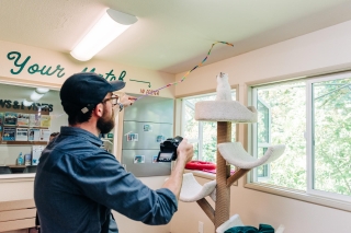 Photo of a man playing with a cat
