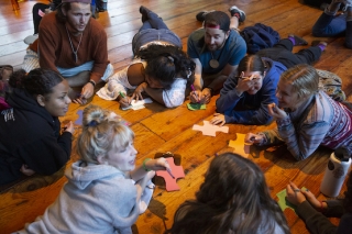Photo of children in a circle working on a project