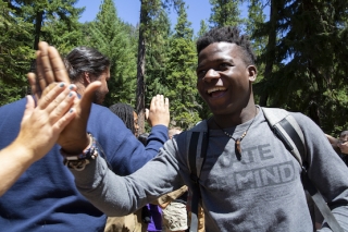 Photo of a boy giving another person a high five