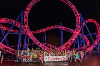 Group photo of kids at a roller coaster