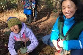 Photo of a family planting trees