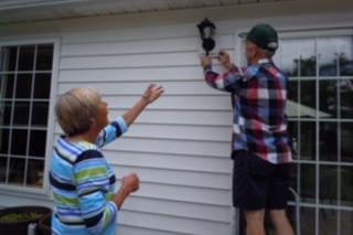 Photo of two people doing house maintenance